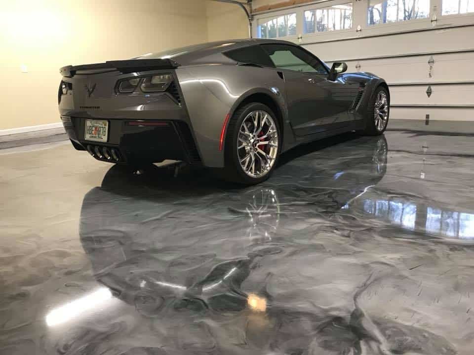 Grey metallic epoxy garage floor with a sports car